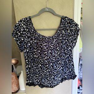 black off the shoulder blouse with blue and white floral print